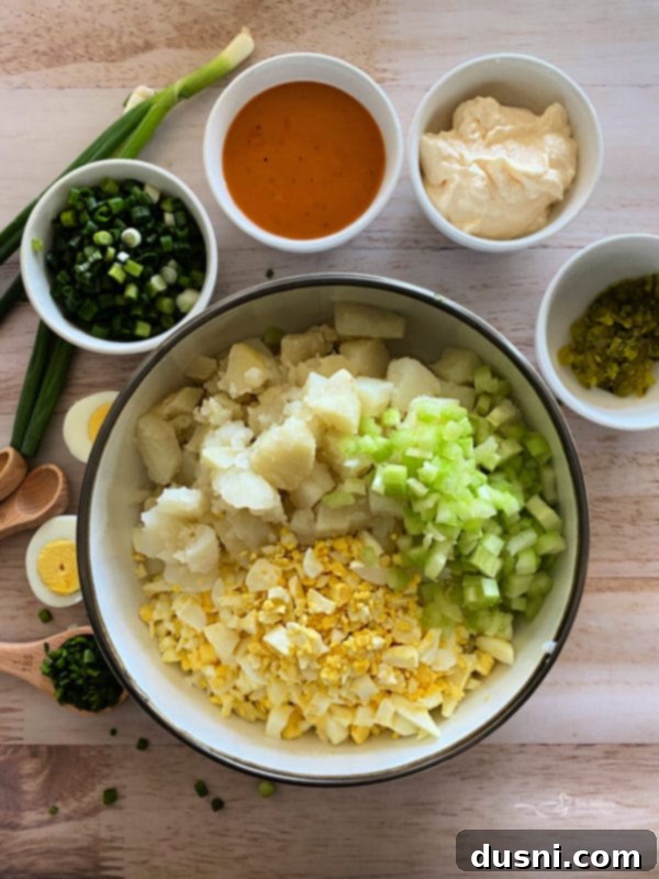 Individual serving of Dorothy's Homemade Potato Salad, garnished with fresh chives, showcasing its creamy texture.
