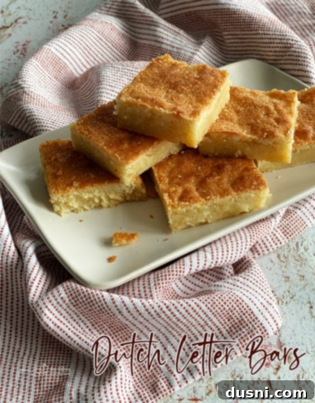 Front view of a generous stack of Dutch Letter bars on a white plate with a linen napkin