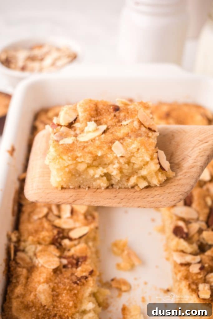 Close-up of a single Dutch Letter Bar with a flaky crust and visible almond filling