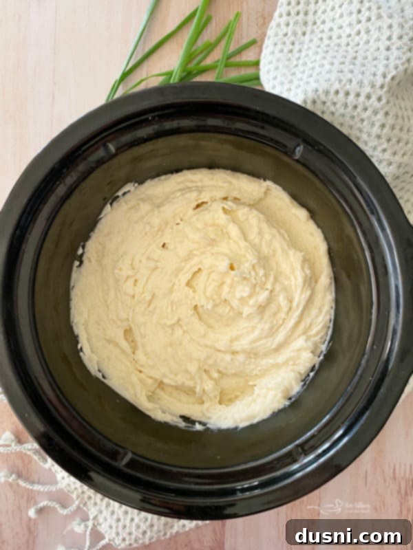 Ultimate Creamy Slow Cooker Mashed Potatoes 19 Close-up of creamy mashed potatoes in slow cooker, ready to serve
