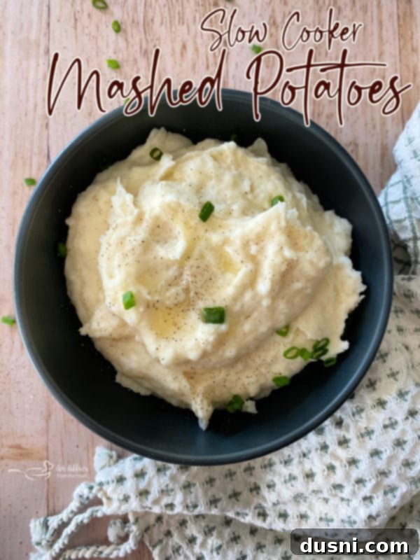 Ultimate Creamy Slow Cooker Mashed Potatoes 21 Top view of mashed potatoes with text overlay: Best Slow Cooker Mashed Potatoes