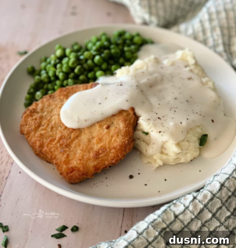 Ultimate Creamy Slow Cooker Mashed Potatoes 4 Plate of southern fried chicken, mashed potatoes, and gravy