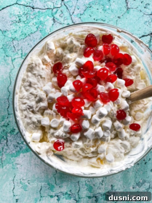 Island Piña Whip 9 Bowl of white pina colada fluff mixture with hints of cherries, before final additions