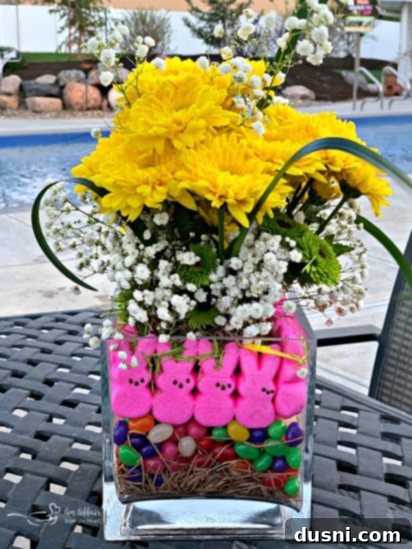 Close-up of an assembled Peep Centerpiece with pink Peep bunnies, colorful jelly beans, and a beautiful bouquet of fresh flowers.