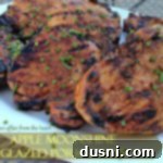Close up of pork chops on a white platter with text "Apple moonshine glazed pork chops"