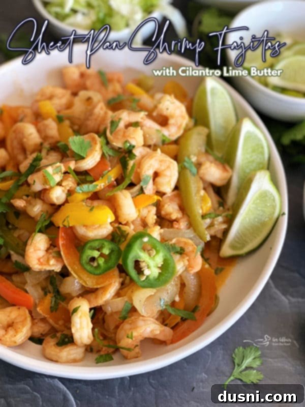 Platter of finished sheet pan shrimp fajitas with cilantro lime butter, ready for serving.