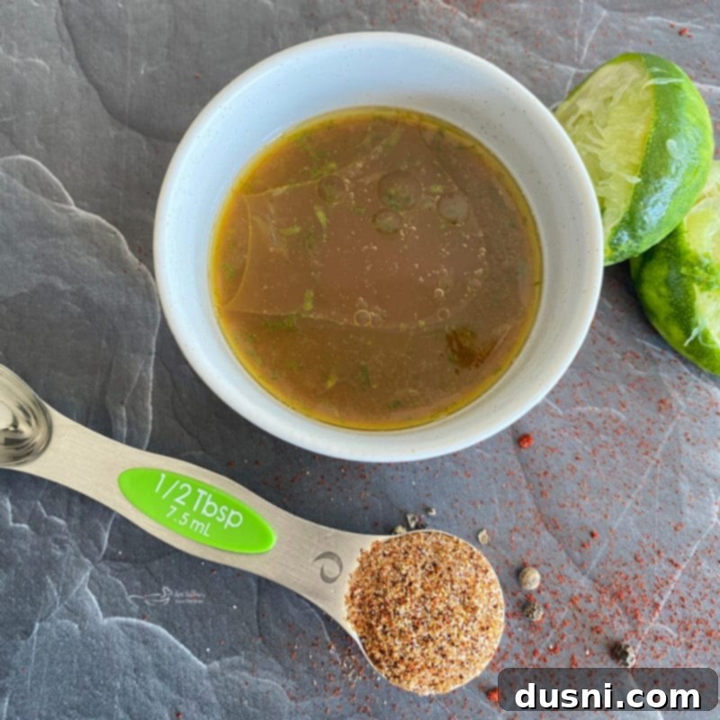 Ingredients for the shrimp fajita marinade, including olive oil, orange juice, soy sauce, lime, and spice mix.
