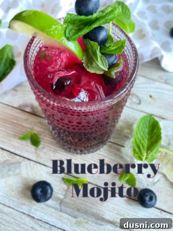 Indigo Berry Refresher 10 Blueberry Mojito served in a clear glass