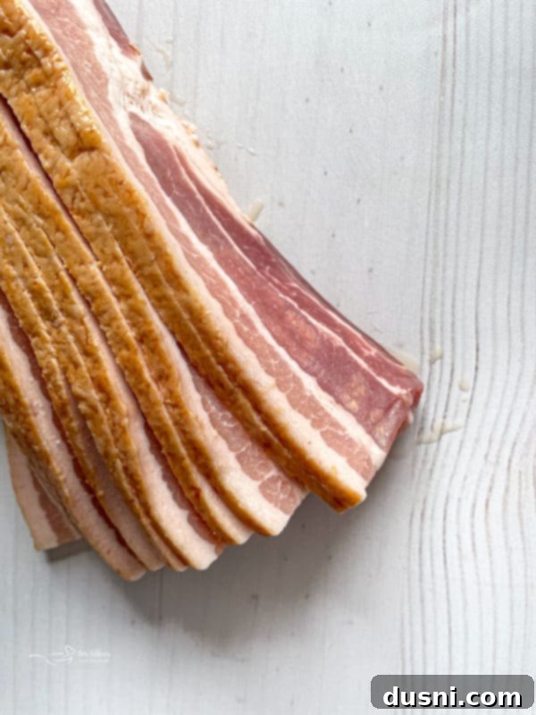 Individual ingredients for the burger toppings: pepper jack cheese, shredded hash browns, thick-cut bacon, and eggs.