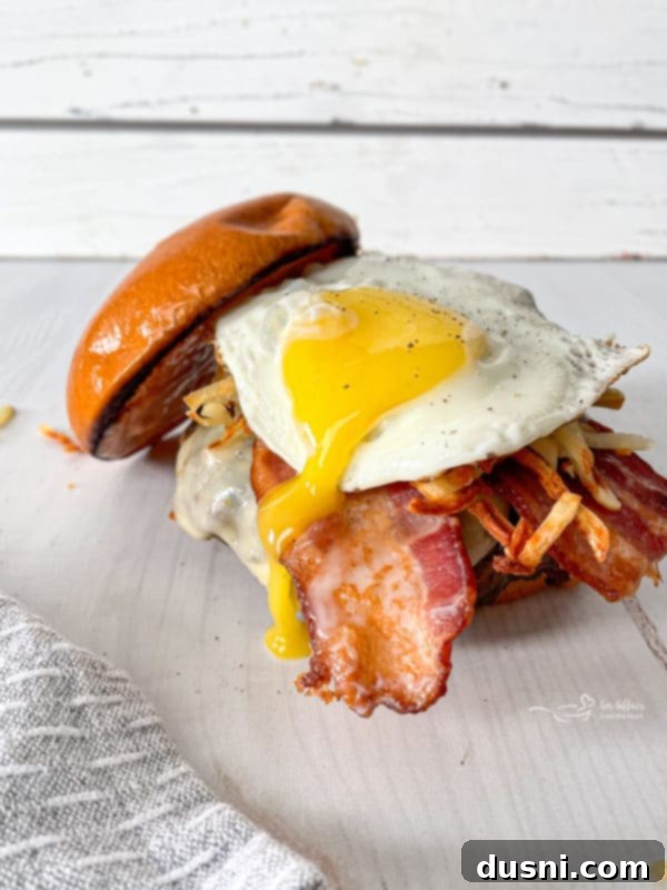 Another delicious view of the Hangover Burger, emphasizing its hearty layers.