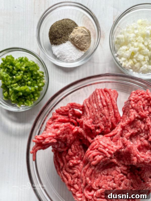 Close-up of raw ingredients for the Hangover Burger: ground beef, jalapeno, onion, and spices.