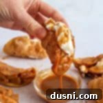 Dipping an Apple Pie Taco into a bowl of caramel sauce.