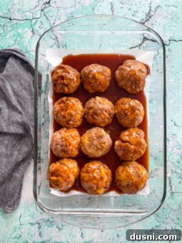 Pineapple Glazed Hawaiian Ham Bites 9 Top view of baked ham balls with sauce