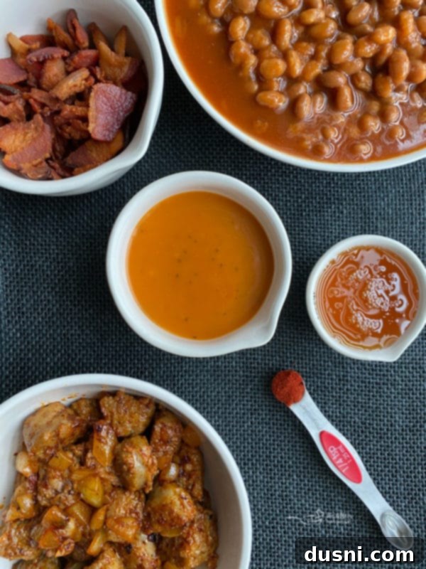 Ultimate Carnivore's Baked Beans 4 Ingredients for Meat Lovers Baked Beans including bacon, bratwurst, onion, spices, and Dorothy Lynch dressing