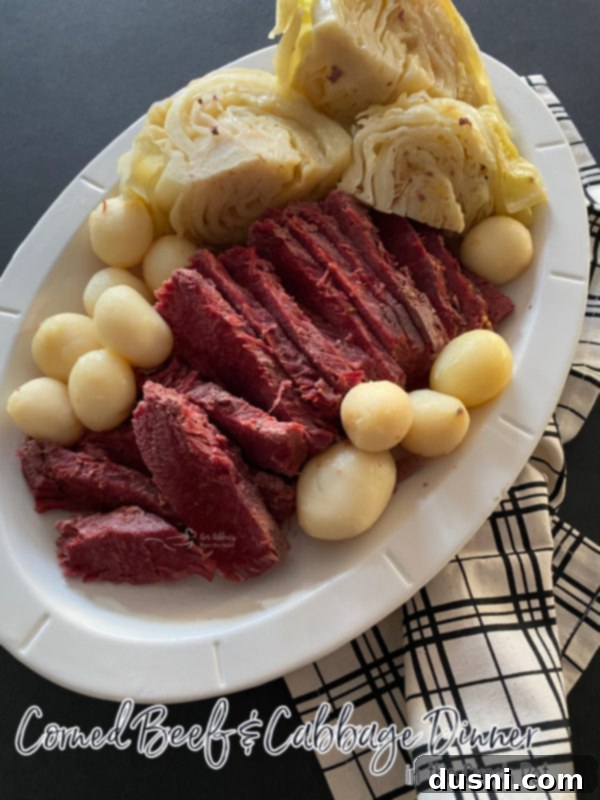 Easy Crock Pot Corned Beef and Cabbage 7 A beautifully plated Slow Cooker Corned Beef and Cabbage with a focus on the tender meat