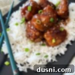 Sticky Asian Meatballs over rice on black plate