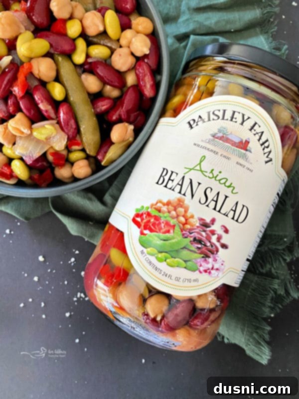 Paisley Farm Asian Bean Salad in a bowl next to fresh ingredients