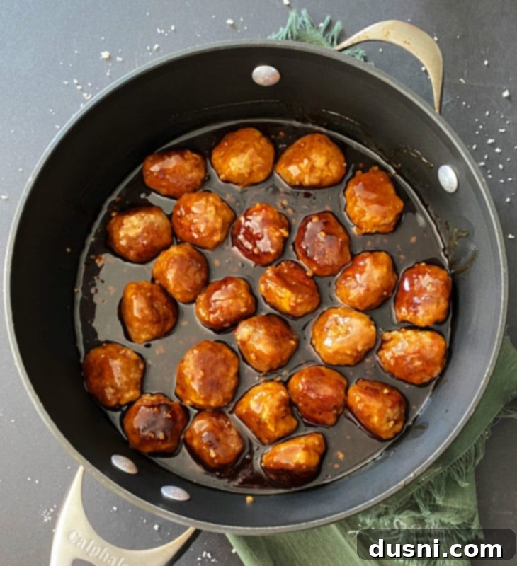 Sticky Asian Meatballs coated in sauce in a skillet