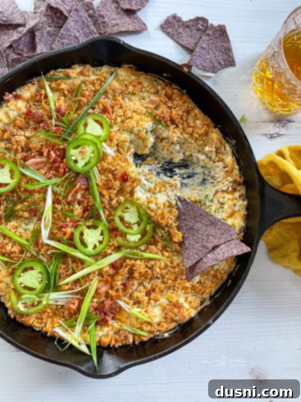 chip being dipped into jalapeño dip