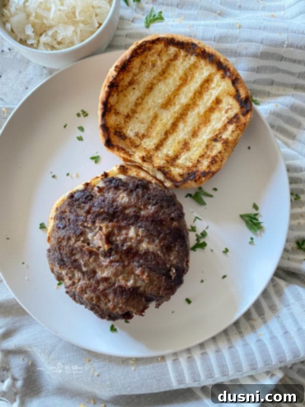 Placing a grilled krautburger on a toasted bun