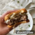 Swiss Cheese Krautburger in hand