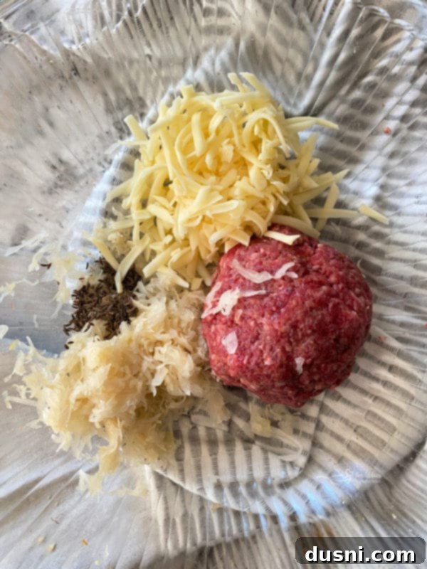 Mixing Swiss cheese and sauerkraut with ground beef