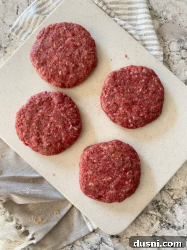 Raw Swiss Cheese Krautburgers ready for grilling
