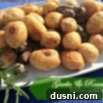 Rustic Garlic Rosemary Heirloom Potatoes 2 garlic & rosemary heirloom potatoes on a white serving platter