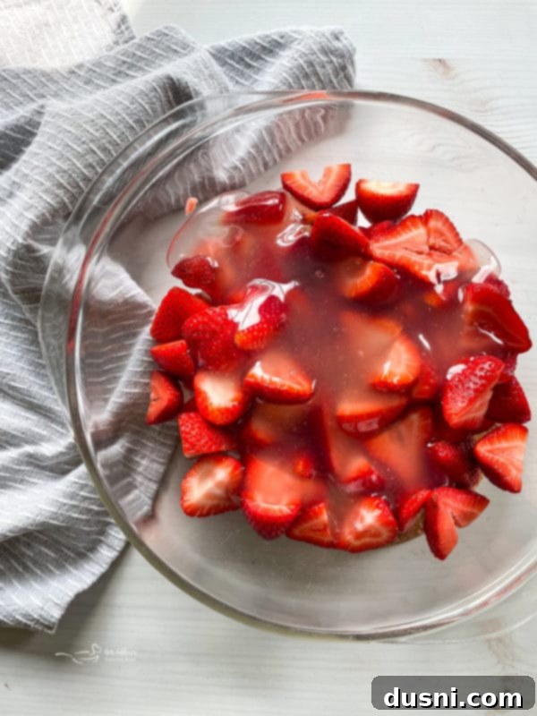 Top view of freshly sliced strawberries coated in a glistening homemade glaze