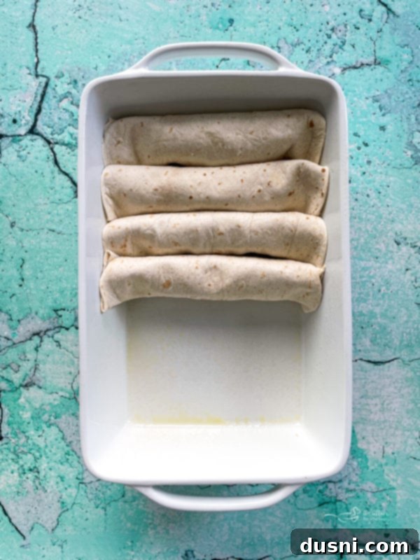 Four enchiladas in white dish