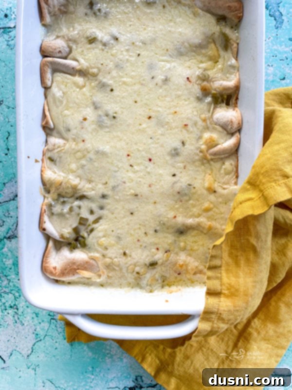 Cheese sauce on top of white chicken enchiladas