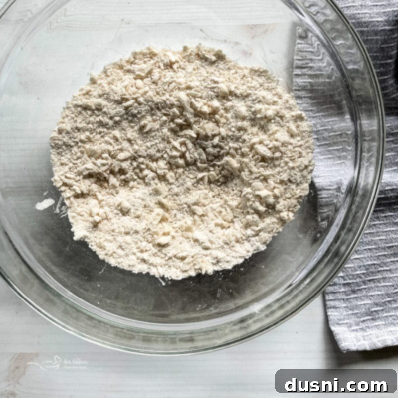 Mixing flour and shortening in a bowl for pie crust