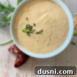 Chipotle Ranch dressing in a white bowl with a light wood background