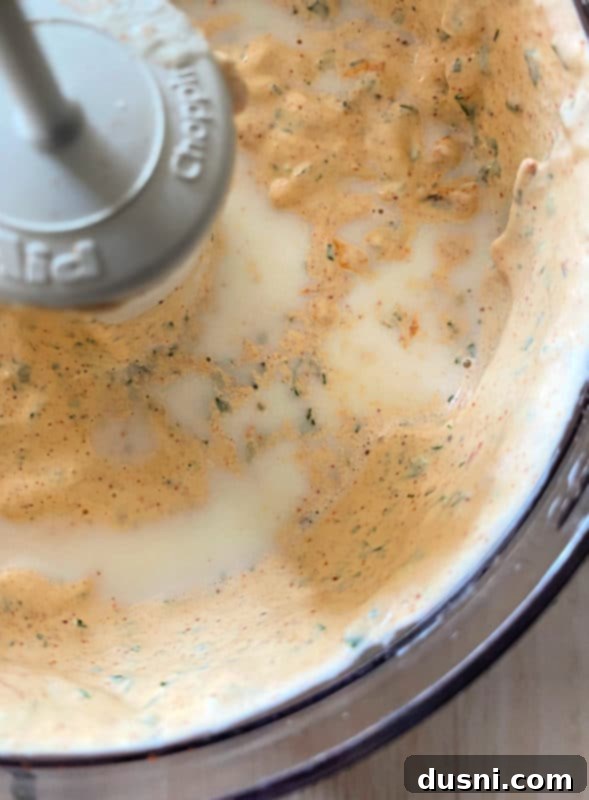 milk being poured into homemade chipotle ranch