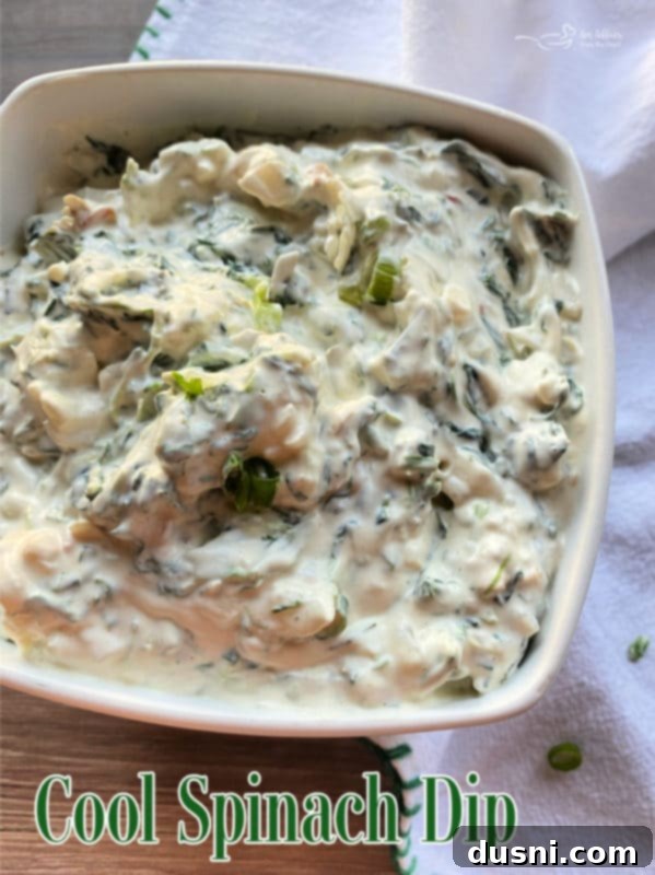 Cool Spinach Dip in a white bowl with crackers