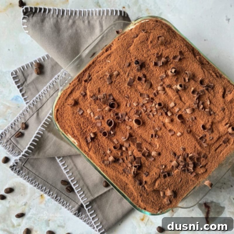 Assembled tiramisu chilling in the refrigerator.