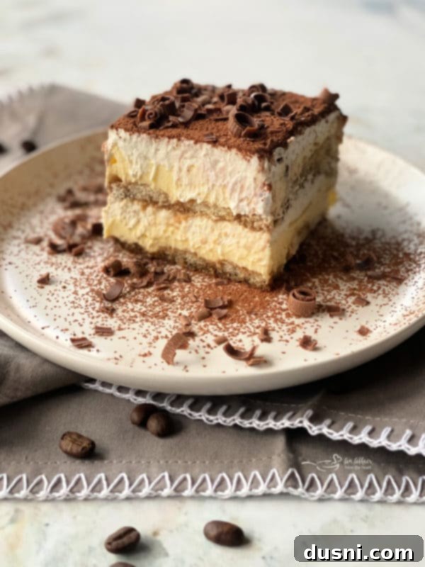Two slices of tiramisu on plates, showing the layers clearly.