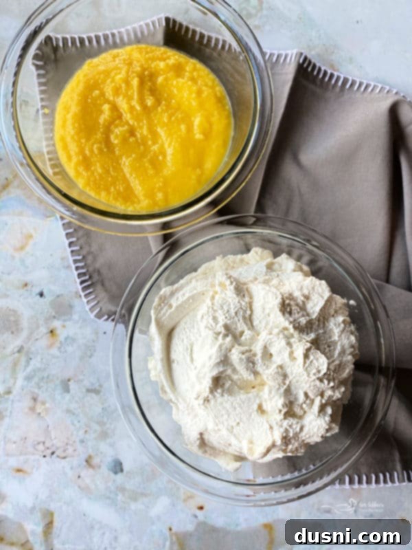 Egg yolks and sugar being whisked in a saucepan.