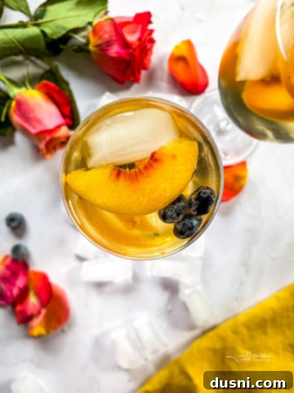 Rose Sangria in a glass with fresh fruit garnish