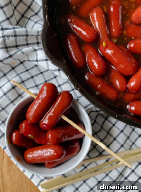 Close-up of Dorothy's BBQ Little Smokies garnished with fresh herbs.