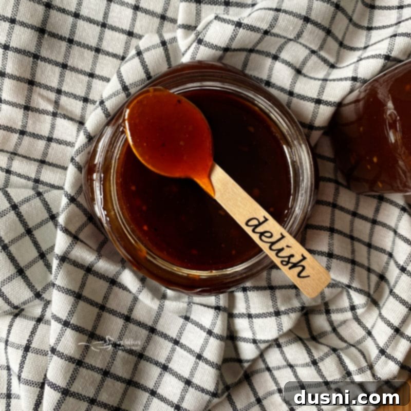 A measuring cup filled with freshly made Dorothy Lynch BBQ Sauce.