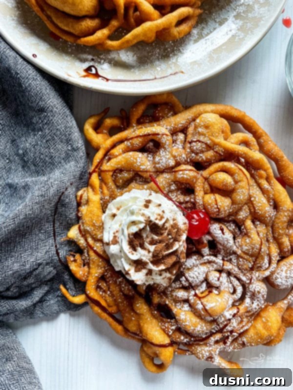 Delicious Funnel Cakes 14 funnel cake with cherry and whipped cream drizzled with chocolate sauce