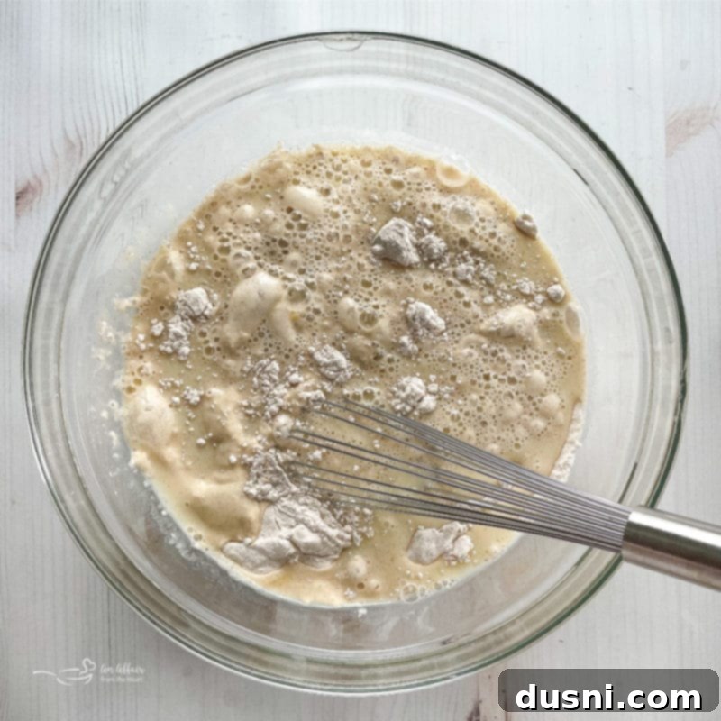 Delicious Funnel Cakes 10 dry ingredients and wet ingredients in glass bowl