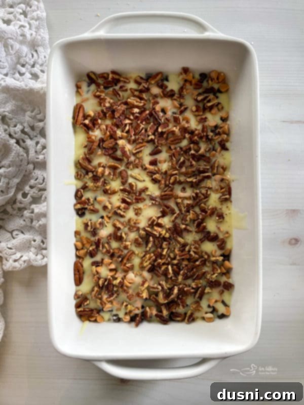 Seven Layer Magic Bars 13 top view of sweetened condensed milk with pecans and butterscotch chips