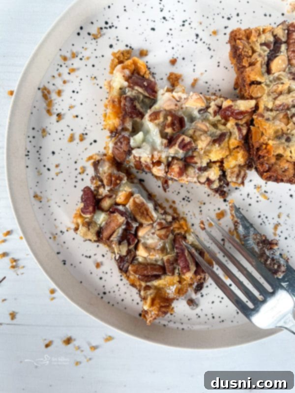 Seven Layer Magic Bars 18 top view of seven layer cookies on plate with fork