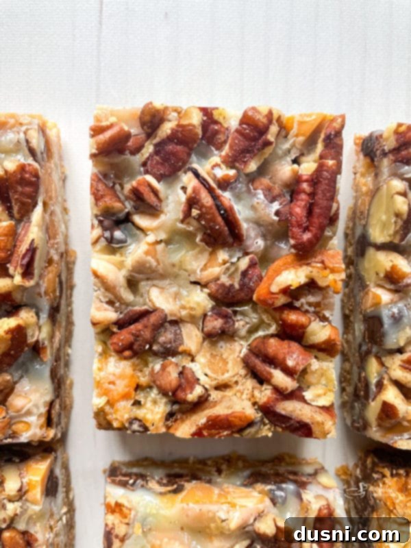 Seven Layer Magic Bars 4 seven layer cookies on white board