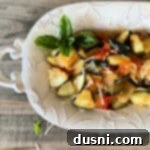 Bonefish Grill Copycat Zucchini and Tomatoes 15 Zucchini & Tomatoes in a white decorative serving plate.