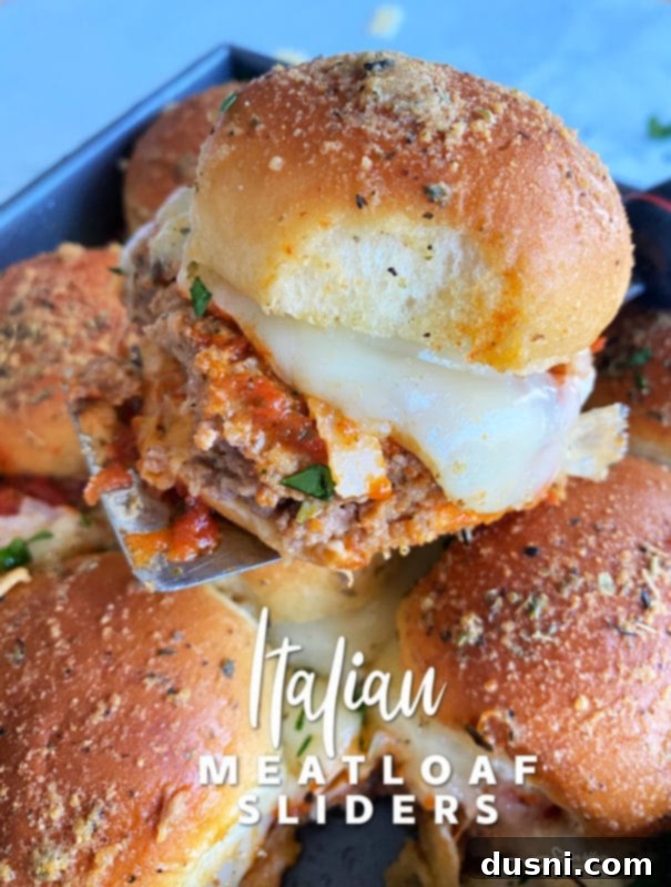 Hearty Italian Meatloaf Sliders 21 Three Italian Meatloaf Sliders stacked on a serving board