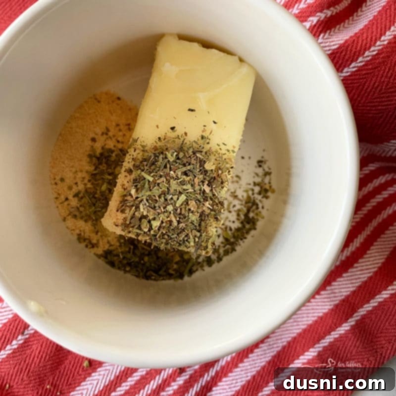 Hearty Italian Meatloaf Sliders 9 Melted butter in a bowl with garlic powder and Italian seasoning