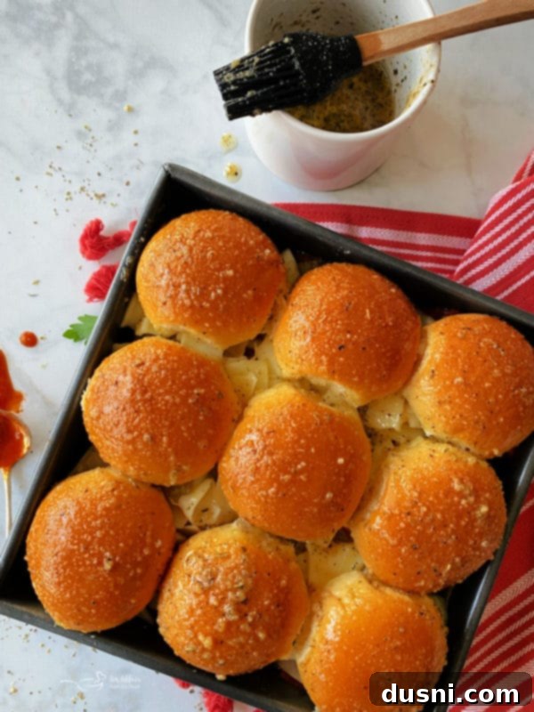 Hearty Italian Meatloaf Sliders 10 Brushing garlic butter mixture onto assembled sliders